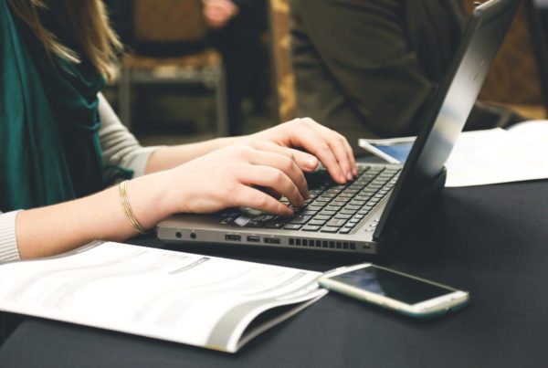 woman typing on laptop computer