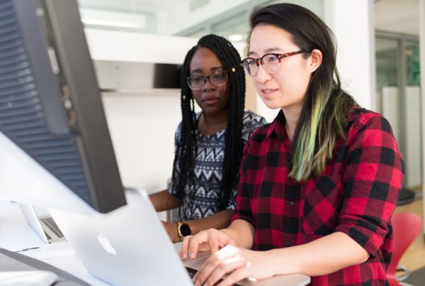 two women work at a computer