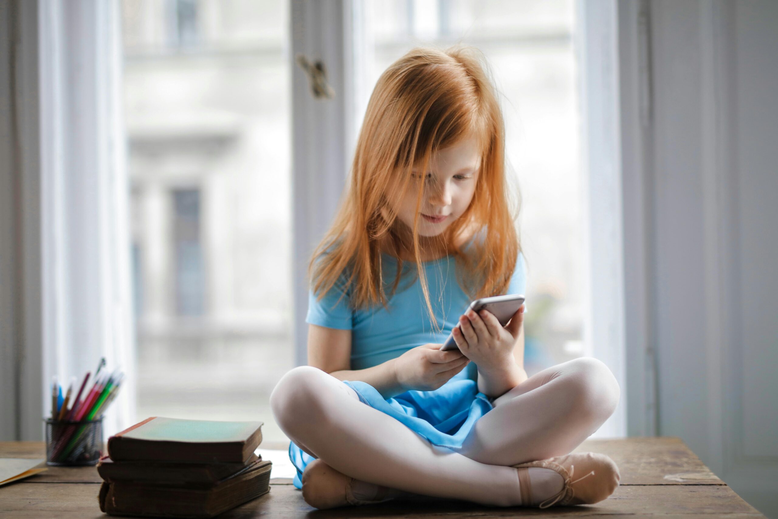 young girl looking at a smartphone